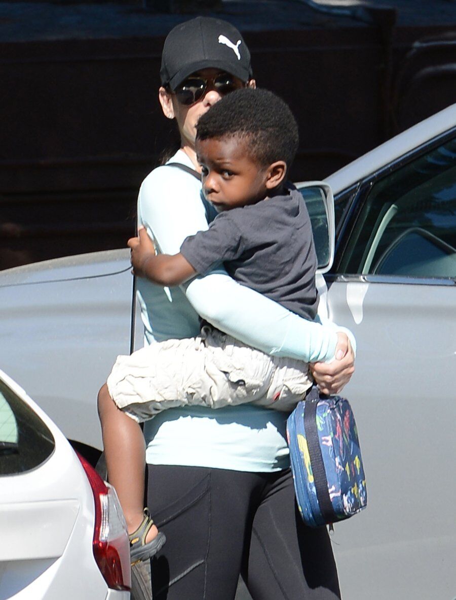 Louis Bardo Bullock carried by her adoptive mother