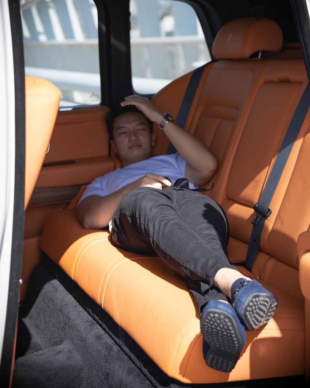 Wayne Liang lying inside a car