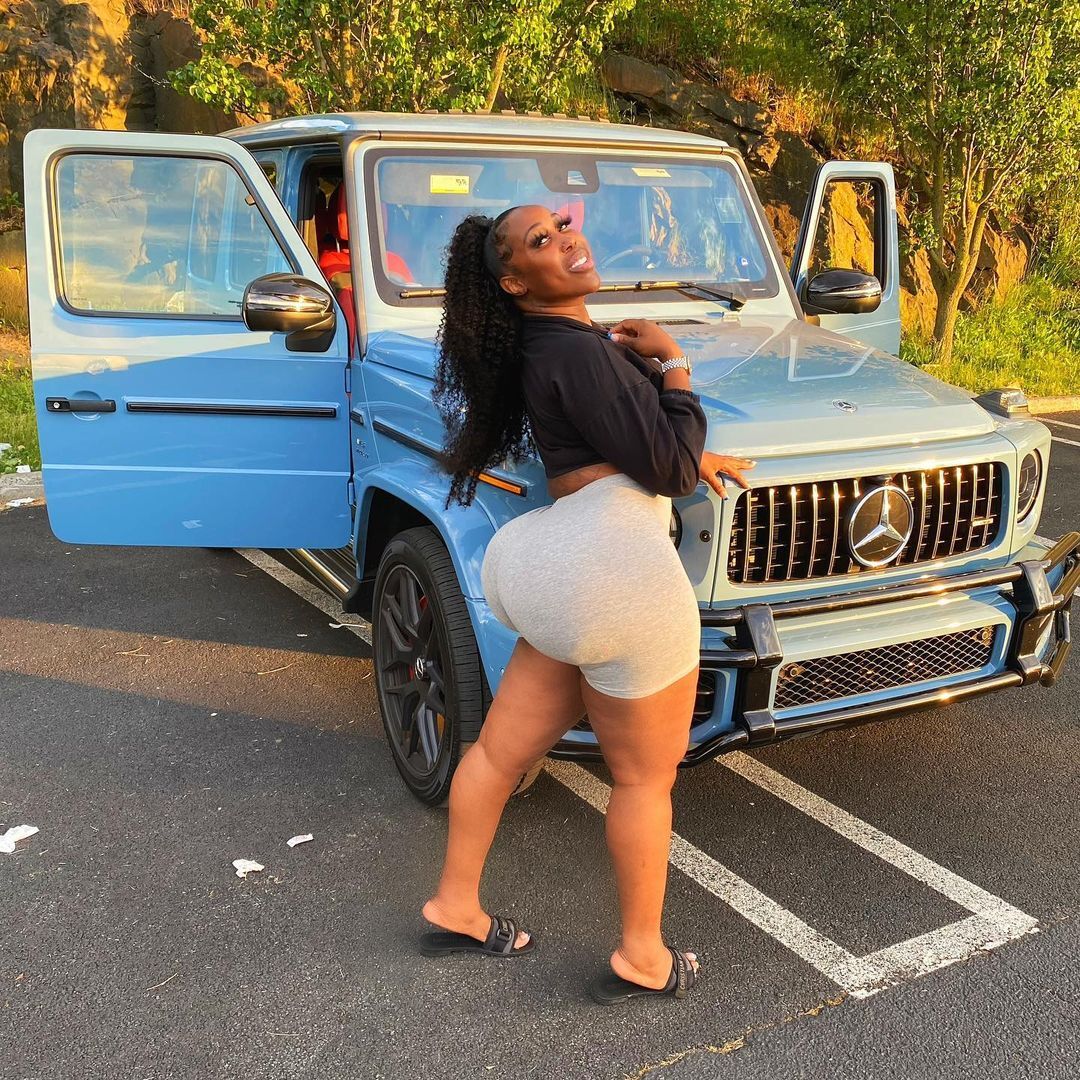 Zmeena Orr posing by her car