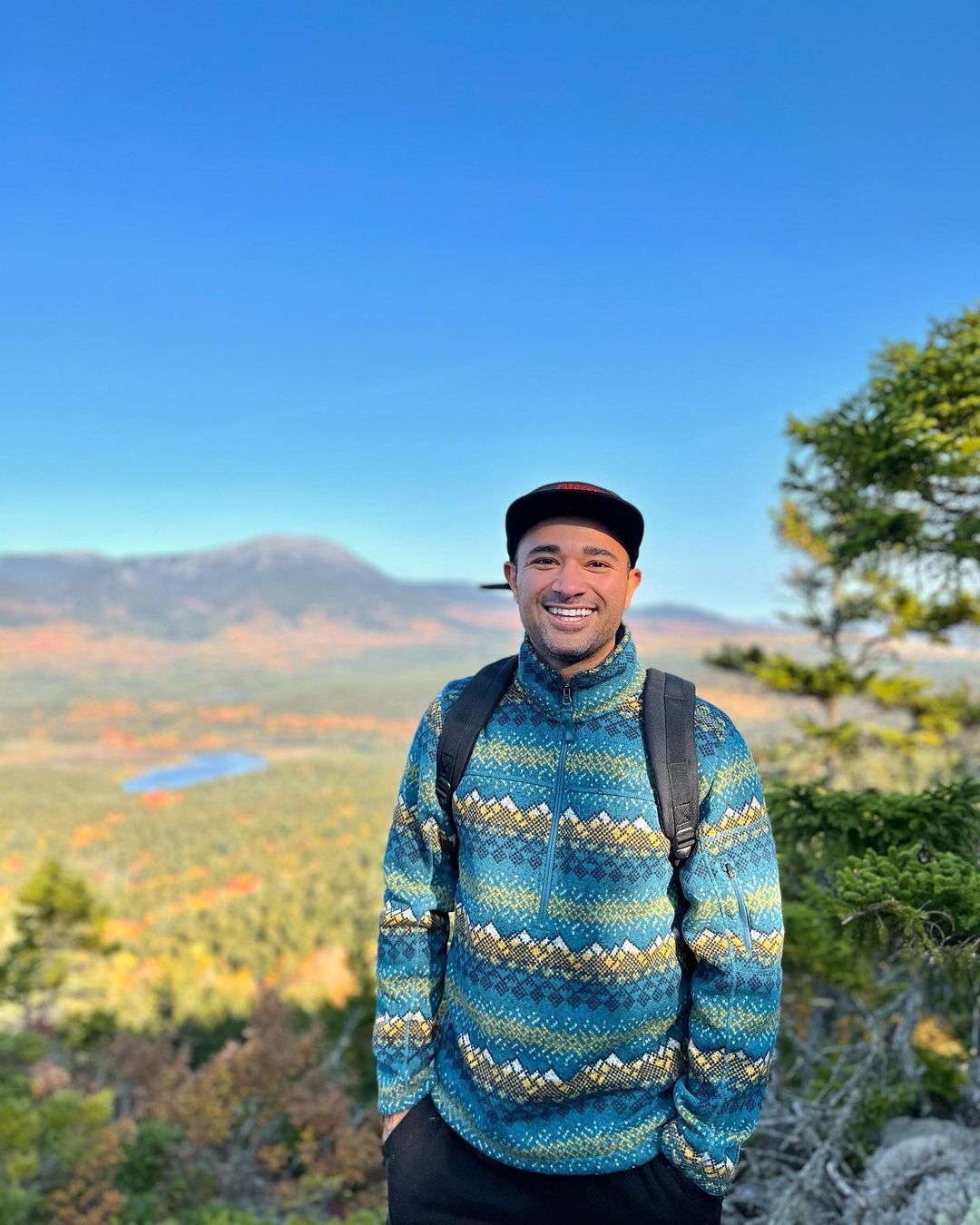 Luis Armand Garcia smiling in the fields