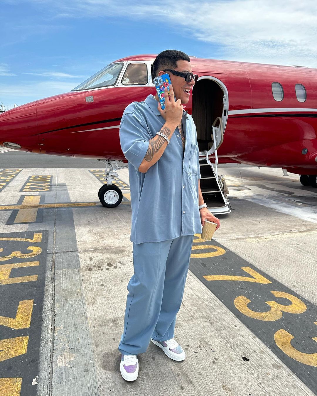 Eduin Caz making call by a red jet