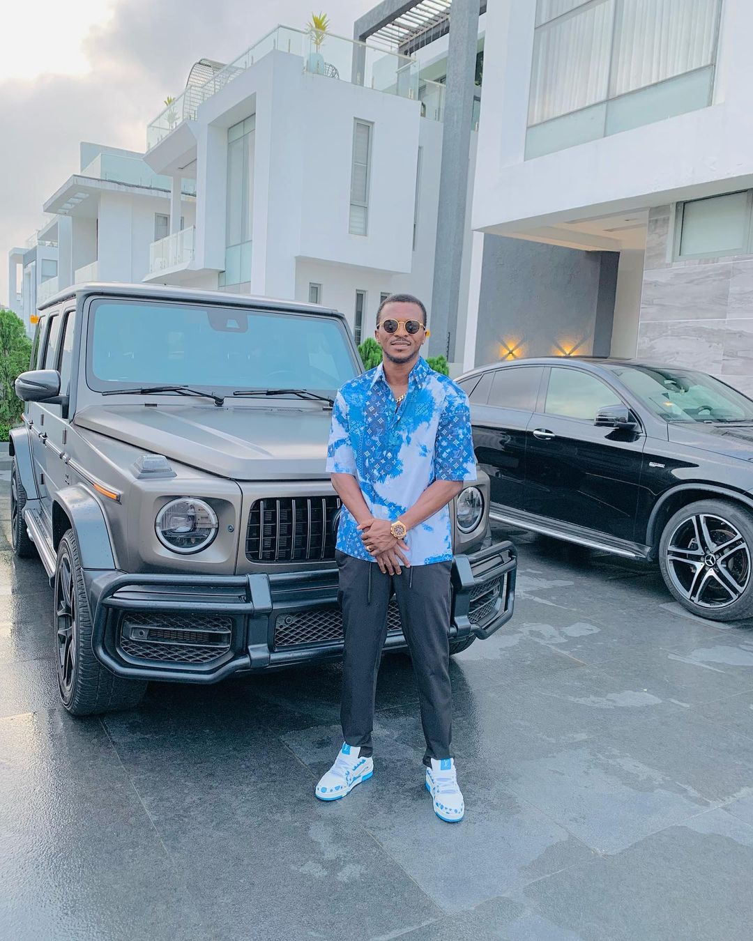 Olarenwaju Kayode posing by his car