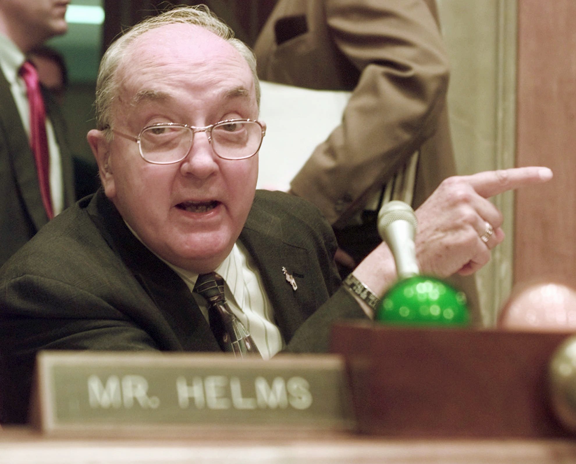 Sen. Jesse Helms points while making comments at the end of a hearing in 1997.