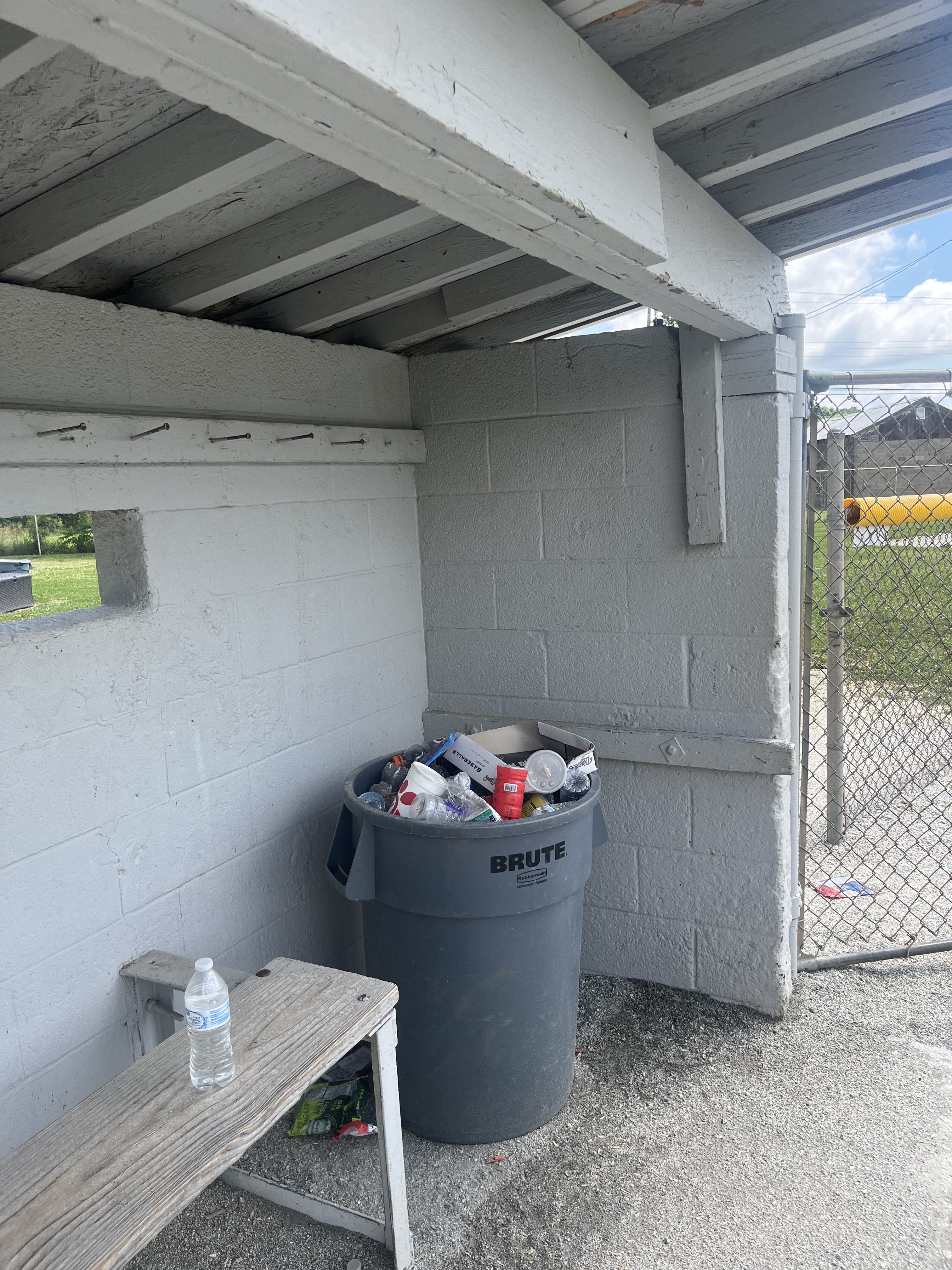 Overflowing trash cans in a dugout at the Summerfield Athletic Park