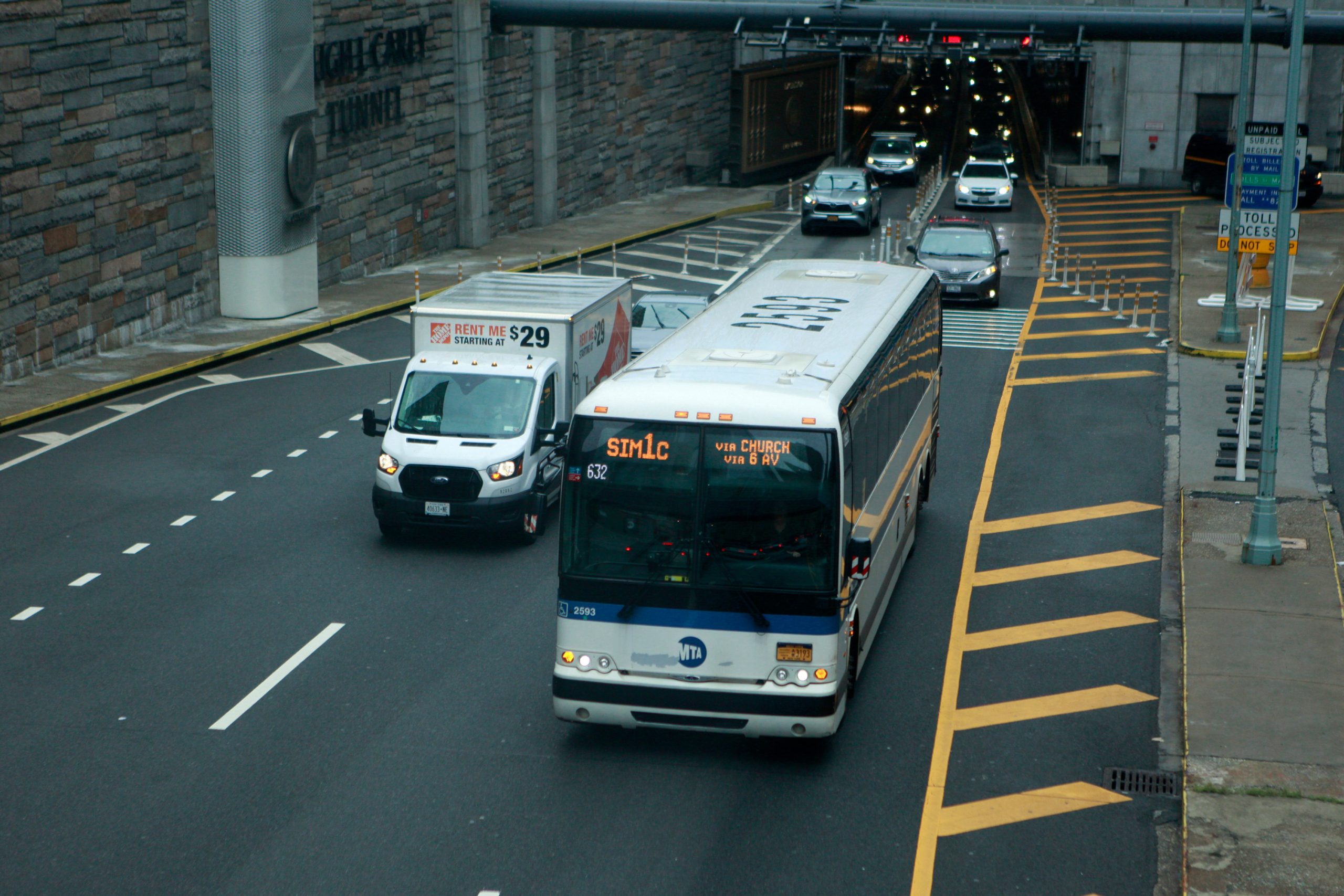 An express bus pulls out of the Hugh L. Carey Tunnel in Lower Manhattan.