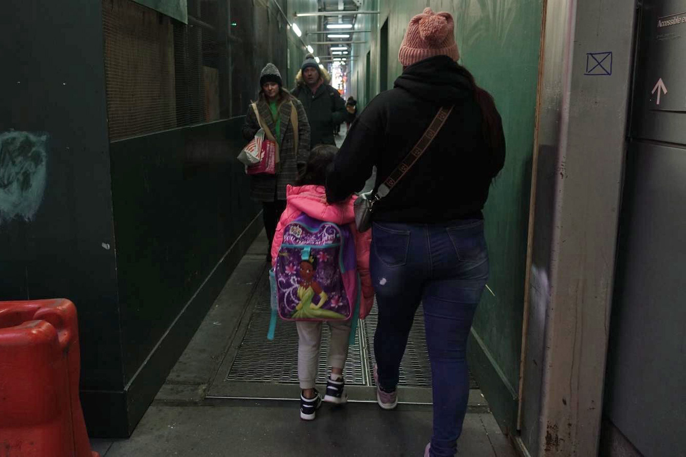 Beatriz walks with one of her two daughters in Midtown while they were staying in a migrant family shelter.