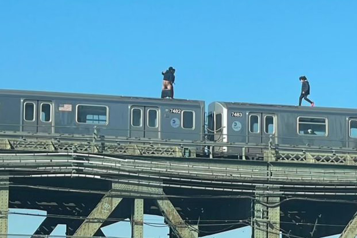 Two people appeared to be getting intimate atop a 7 train.