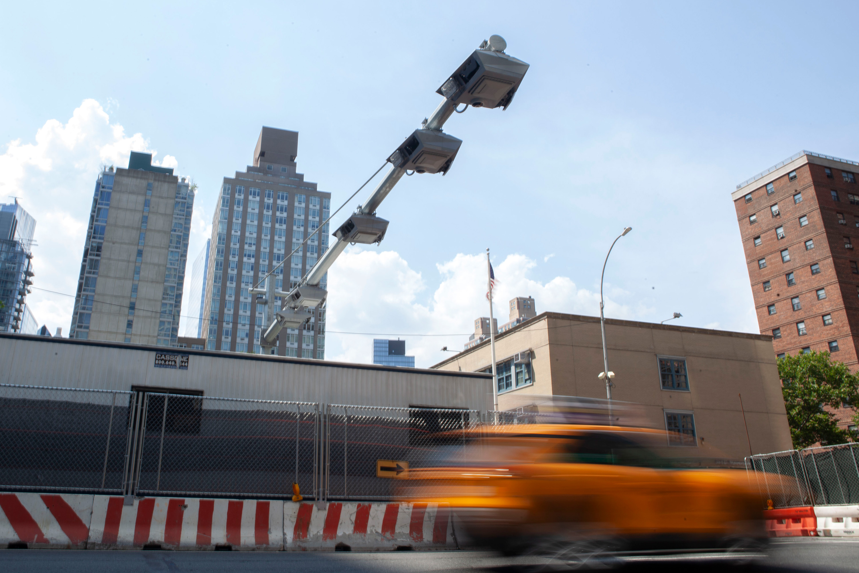 A cabbie drives under a congestion pricing toll placed at 60th Street and 11th Avenue before the plan was put on indefinite hold.