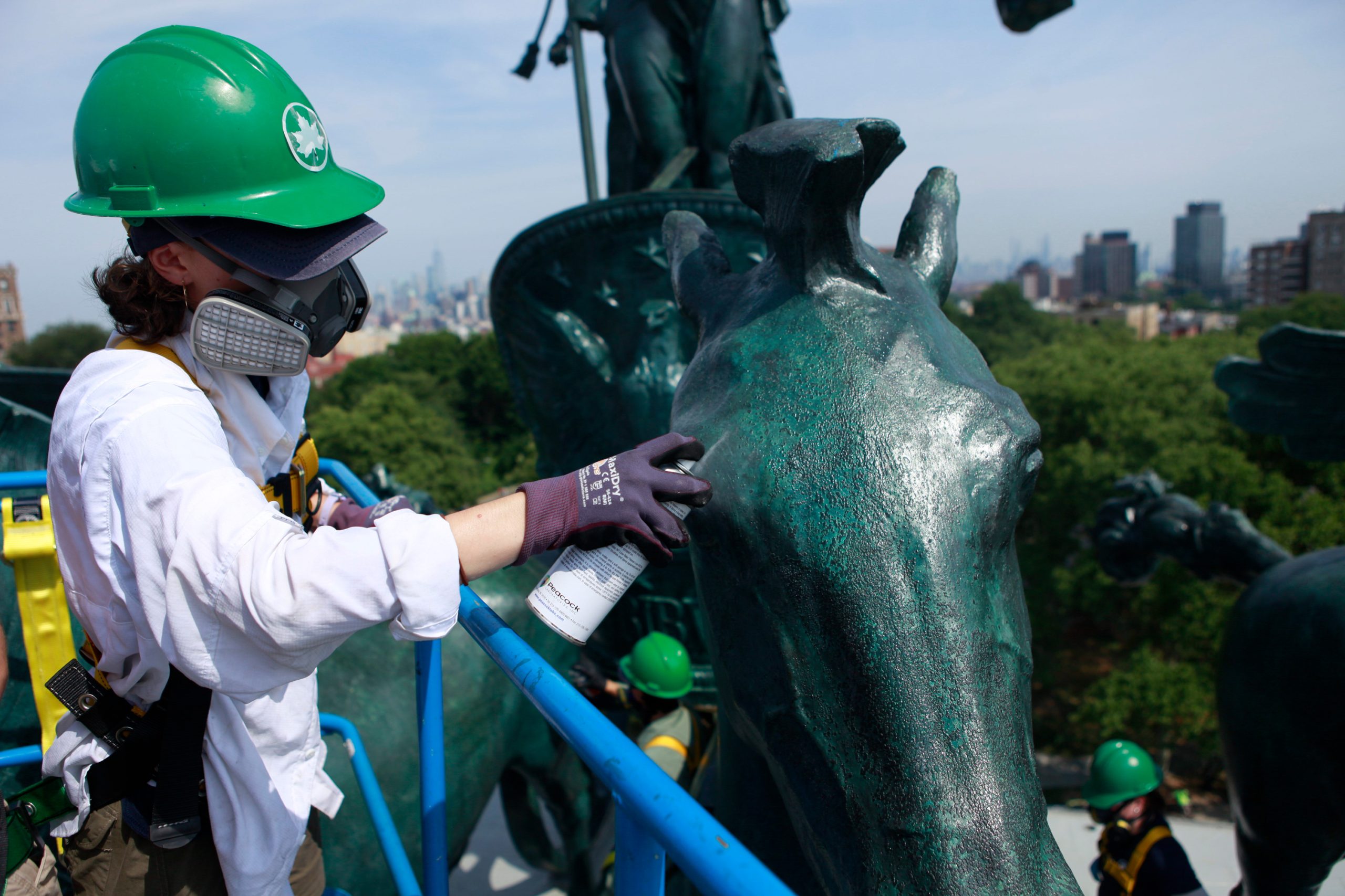Parks Department intern Abigail Lenhard helps restore sculptures atop the Grand Army Plaza arch.