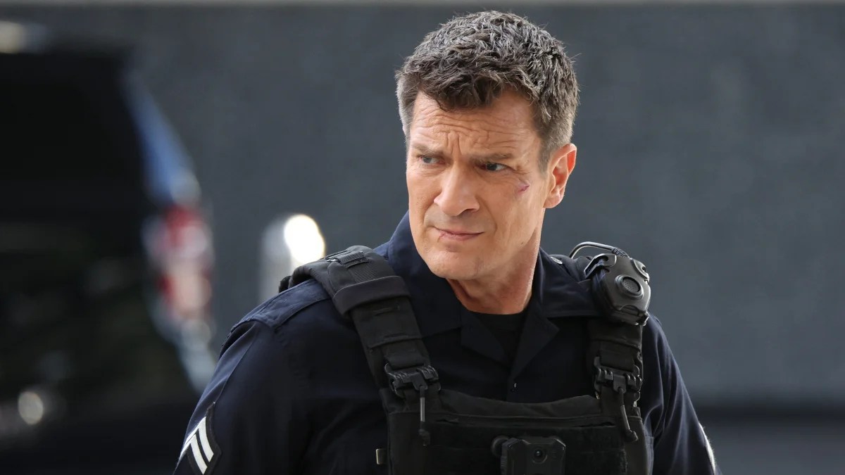 Nathan Fillion stars as John Nolan, a police officer in a bulletproof vest looking to the left of the frame