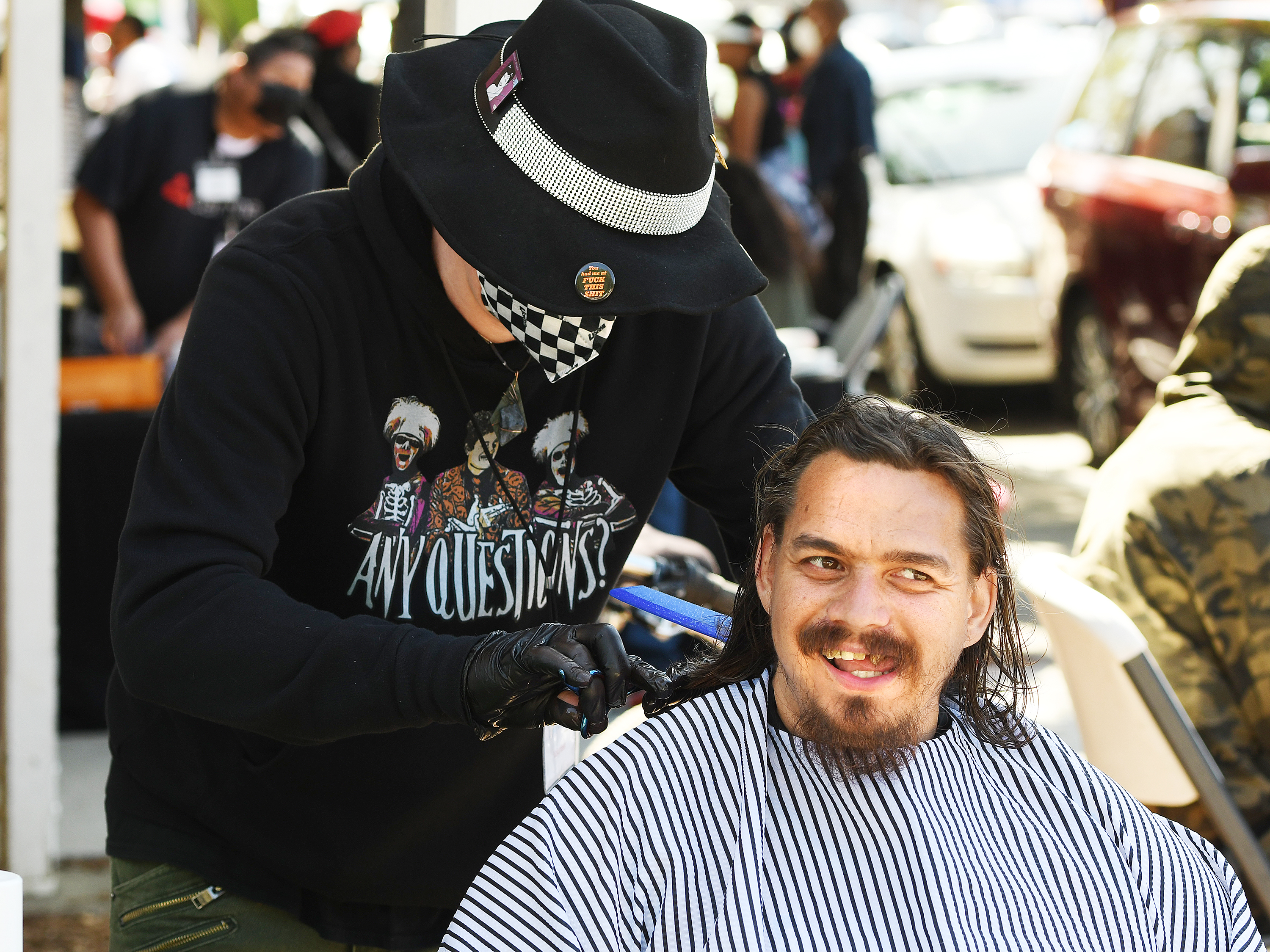 Lee Maren smiles as he gets his hair cut by John Norton from Medusa's Salon during Dignity Day on Saturday. (Chris Riley/Times-Herald)