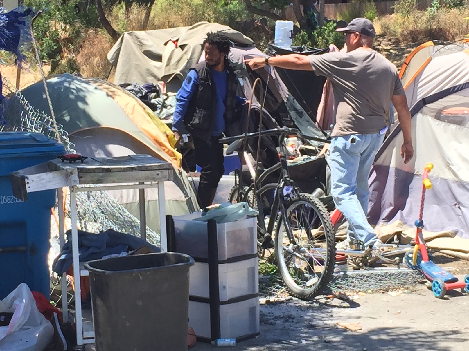 Housing advocate Joey Carrizales does his best to help the unsheltered collect their items during a city-ordered debris removal on Monday. (Thomas Gase -- Times-Herald)
