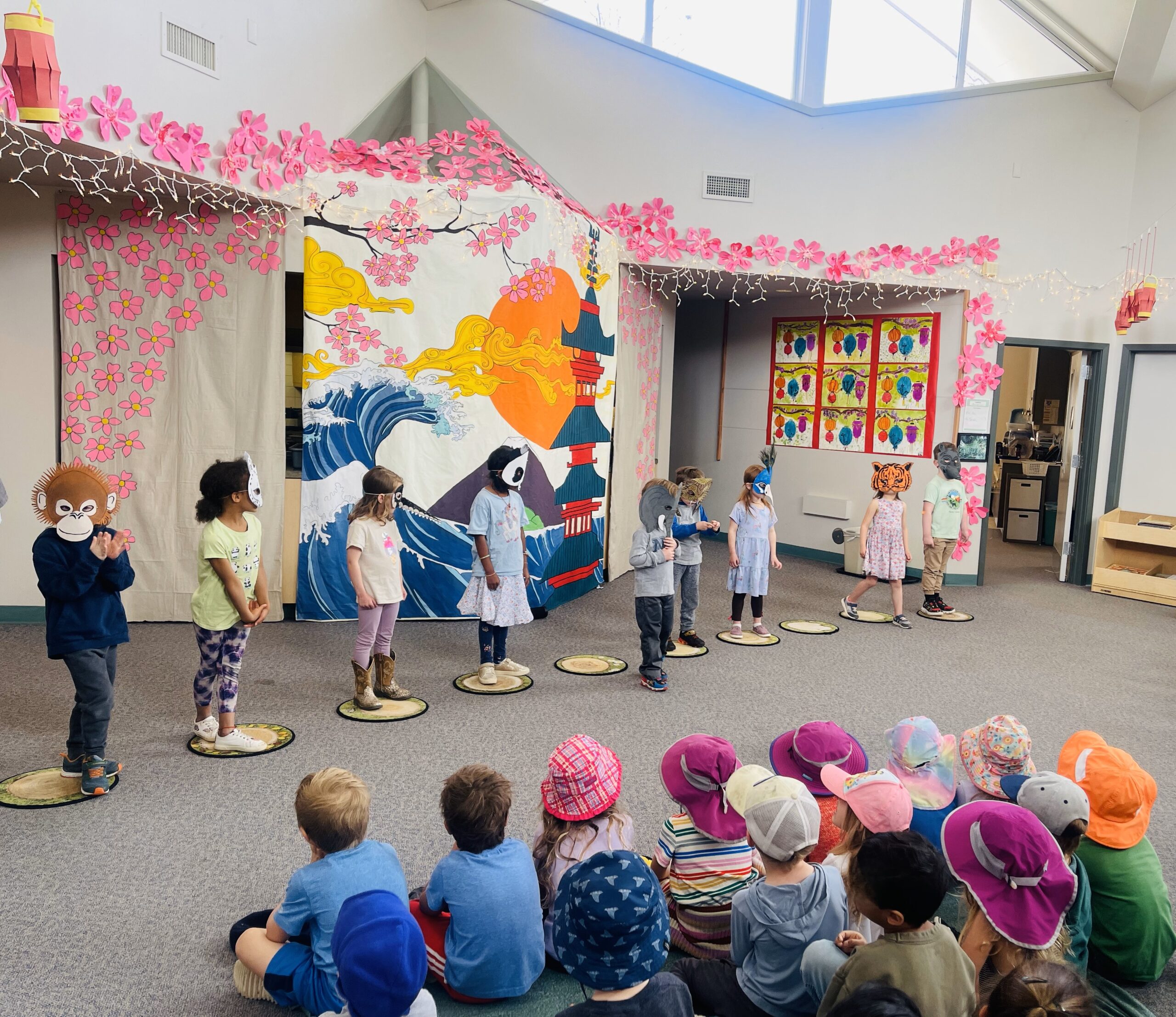 Children in animal masks prepare for the Kindergarten Art Show