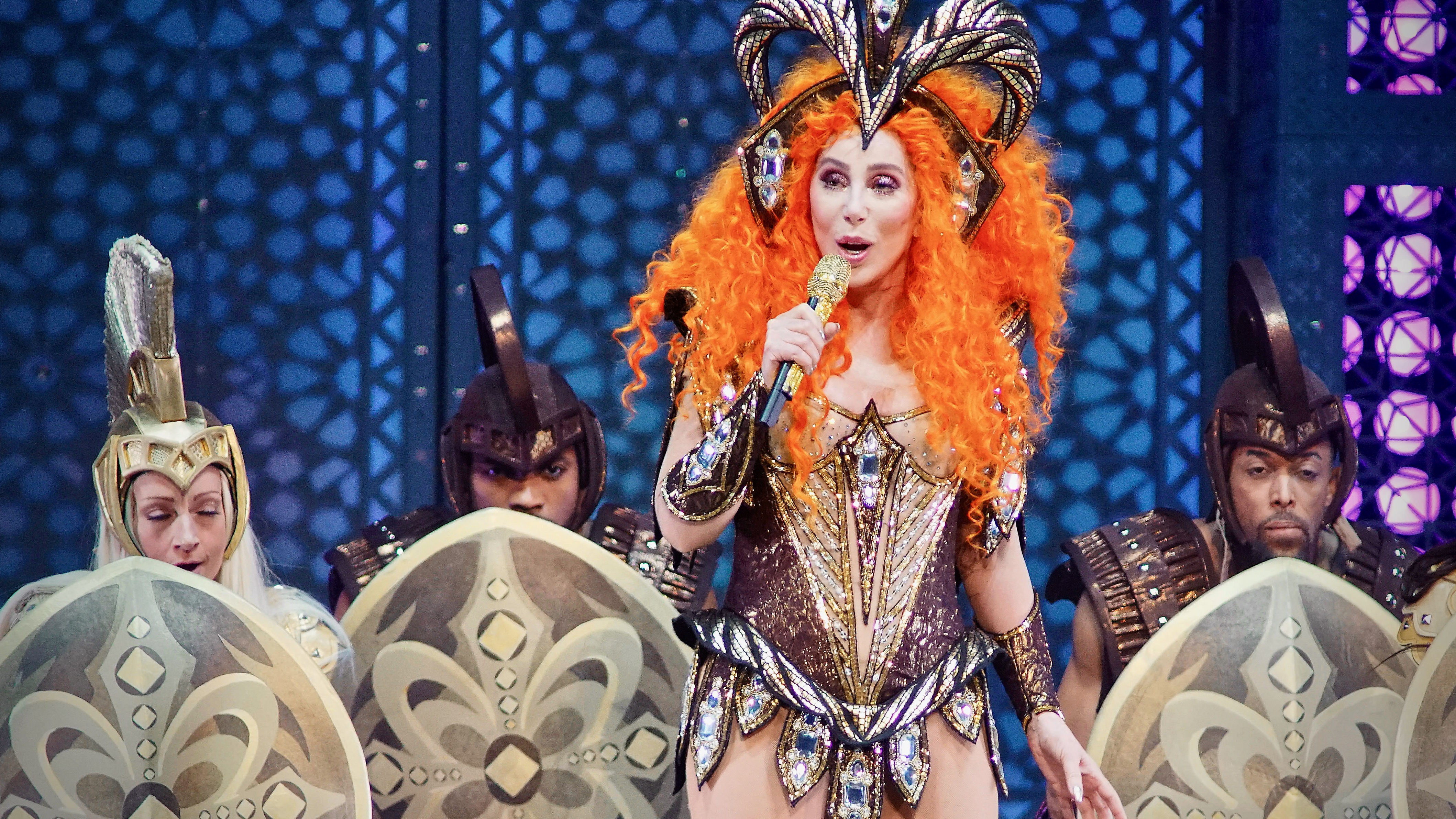 Cher performs in an elaborate outfit. 