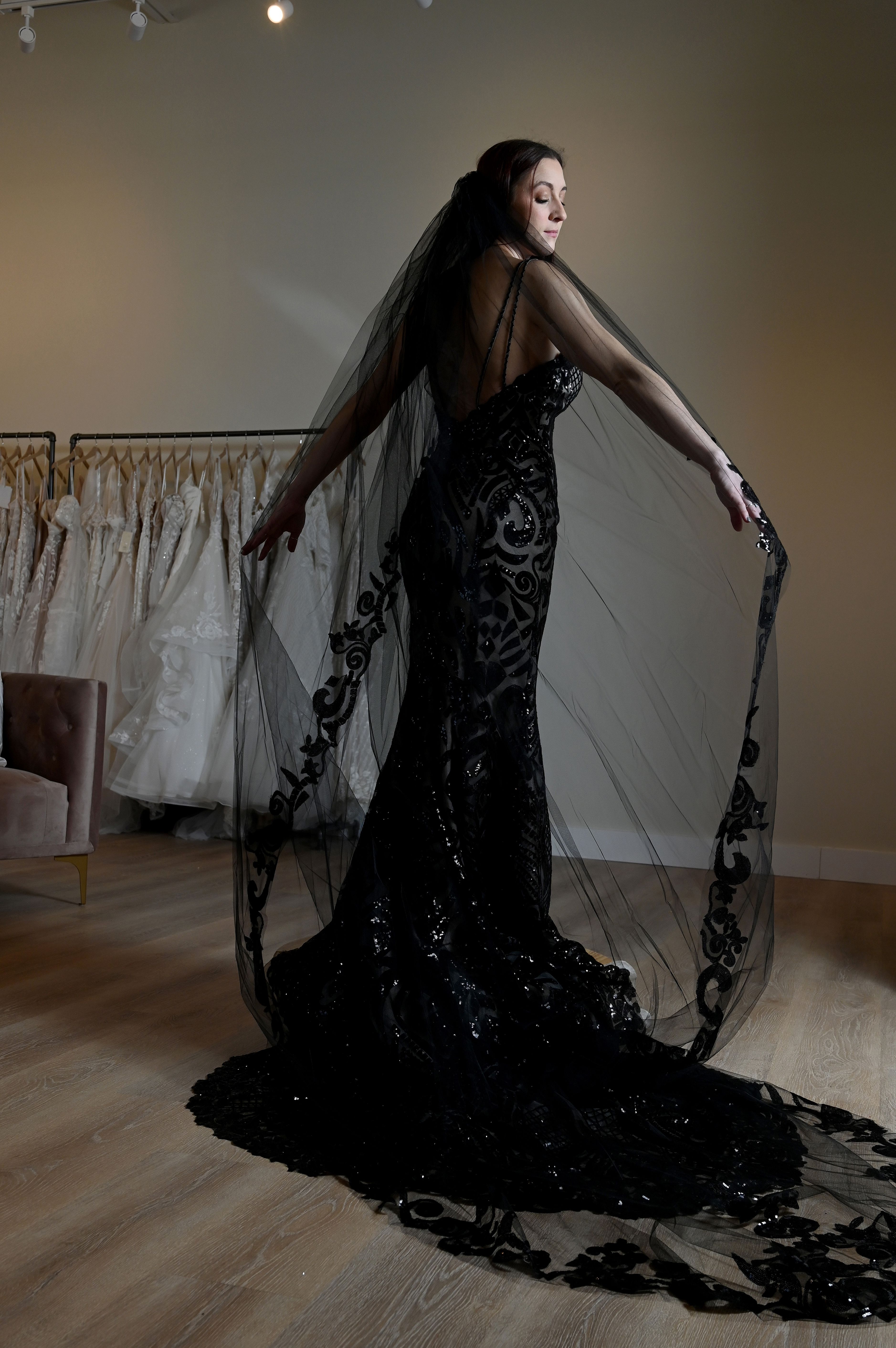 Kailee Bull, of Severna Park, wears a non-traditional wedding she purchased at Amanda's Bridal Loft of Annapolis. She had the black sequin lace dress customized with a lowered back, double strap and cathedral veil. (Kim Hairston/Baltimore Sun)