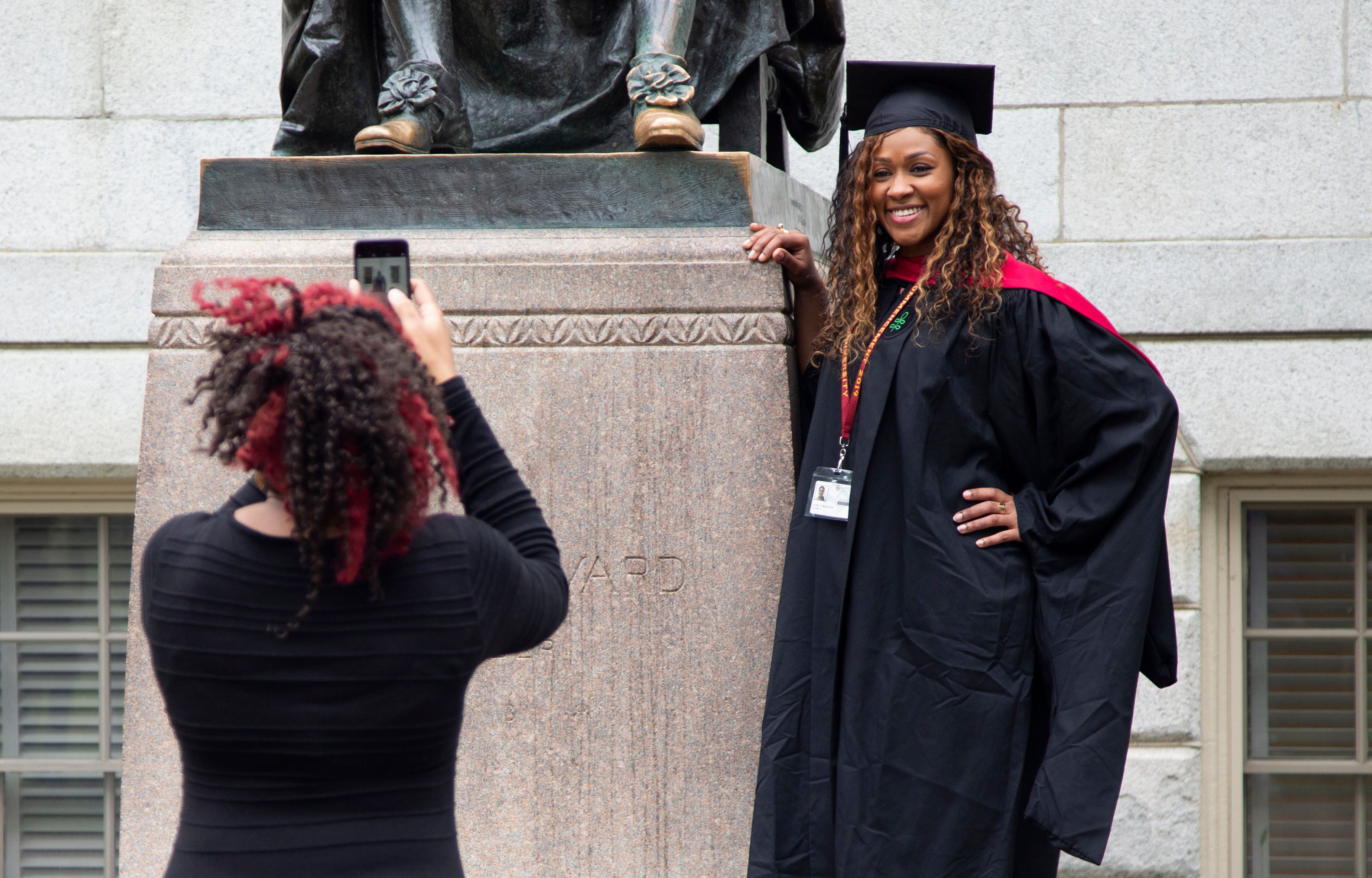 A graduate poses for a photo during Harvard's 368th commencement ceremony at Harvard University in Cambridge, Massachusetts, on May 30, 2019. (Photo by Allison Dinner / AFP) (Photo credit should read ALLISON DINNER/AFP via Getty Images)