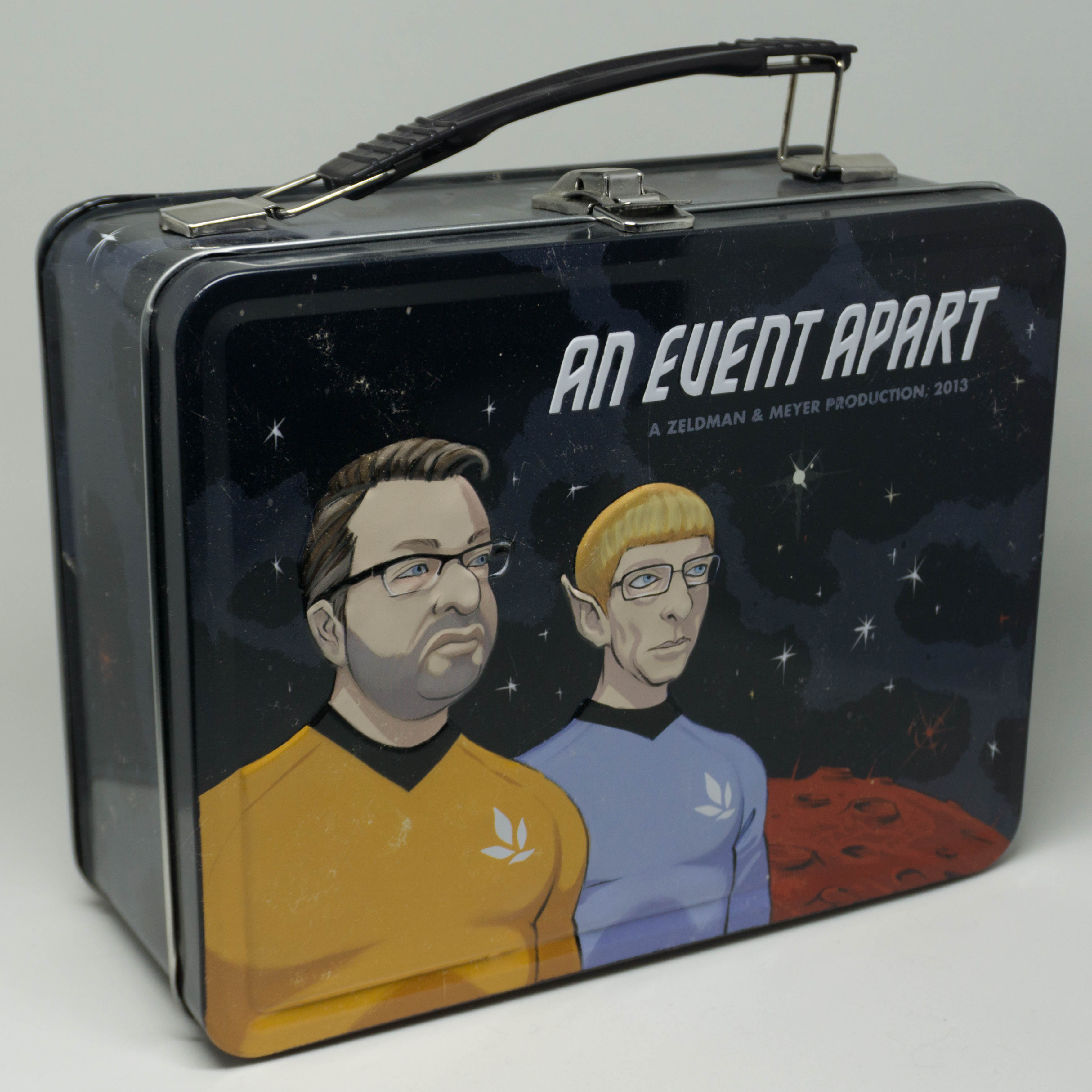 An Event Apart 2013 limited edition lunchbox; illustration by Kevin Cornell. Eric Meyer as Spock, Jeffrey Zeldman as Kirk.