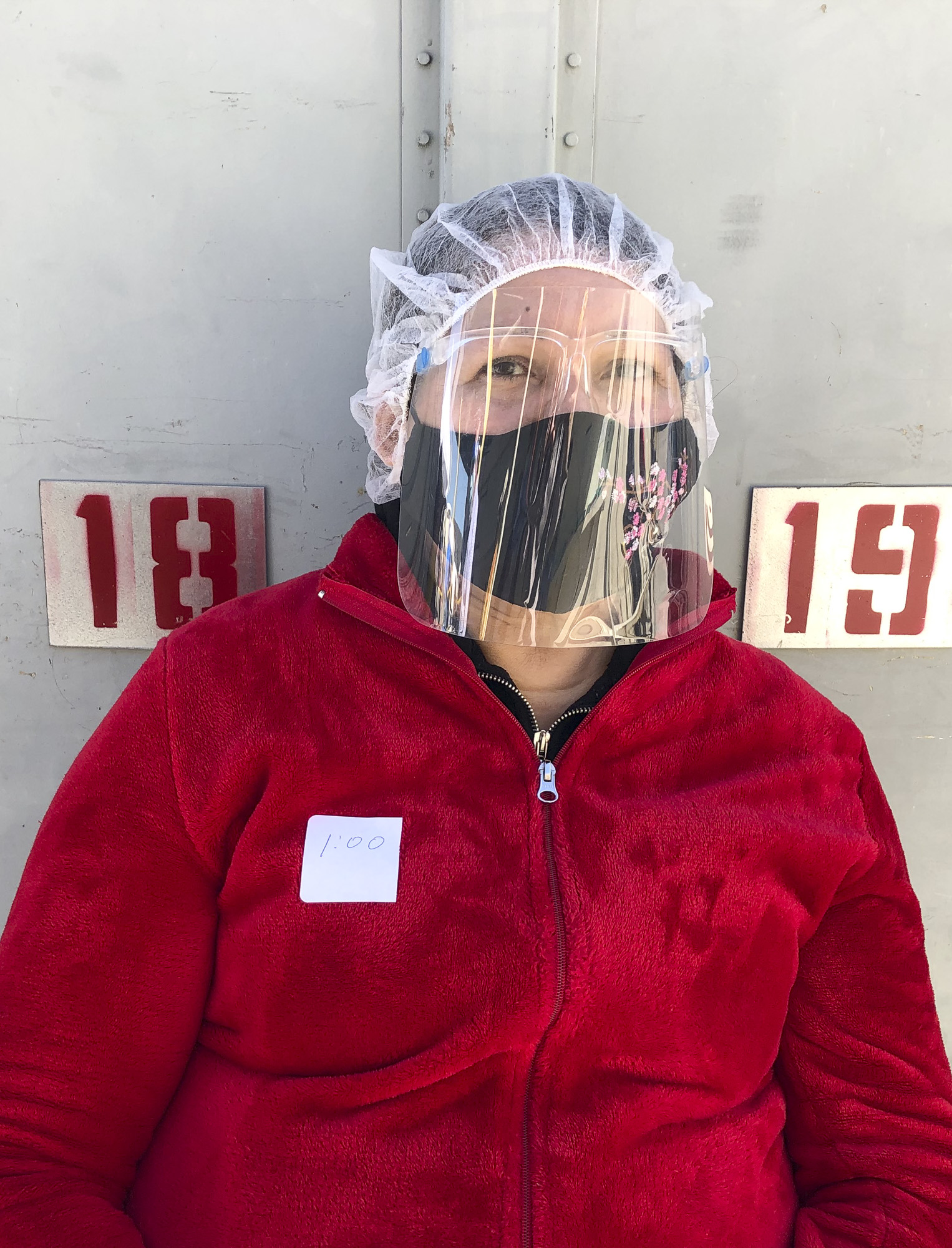 Maria Cruz of San Jose sits in the observation area after getting her COVID-19 vaccine at her job site, Monterey Mushrooms in Morgan Hill on Feb. 28, 2021. Photo by Ana Ibarra, CalMatters