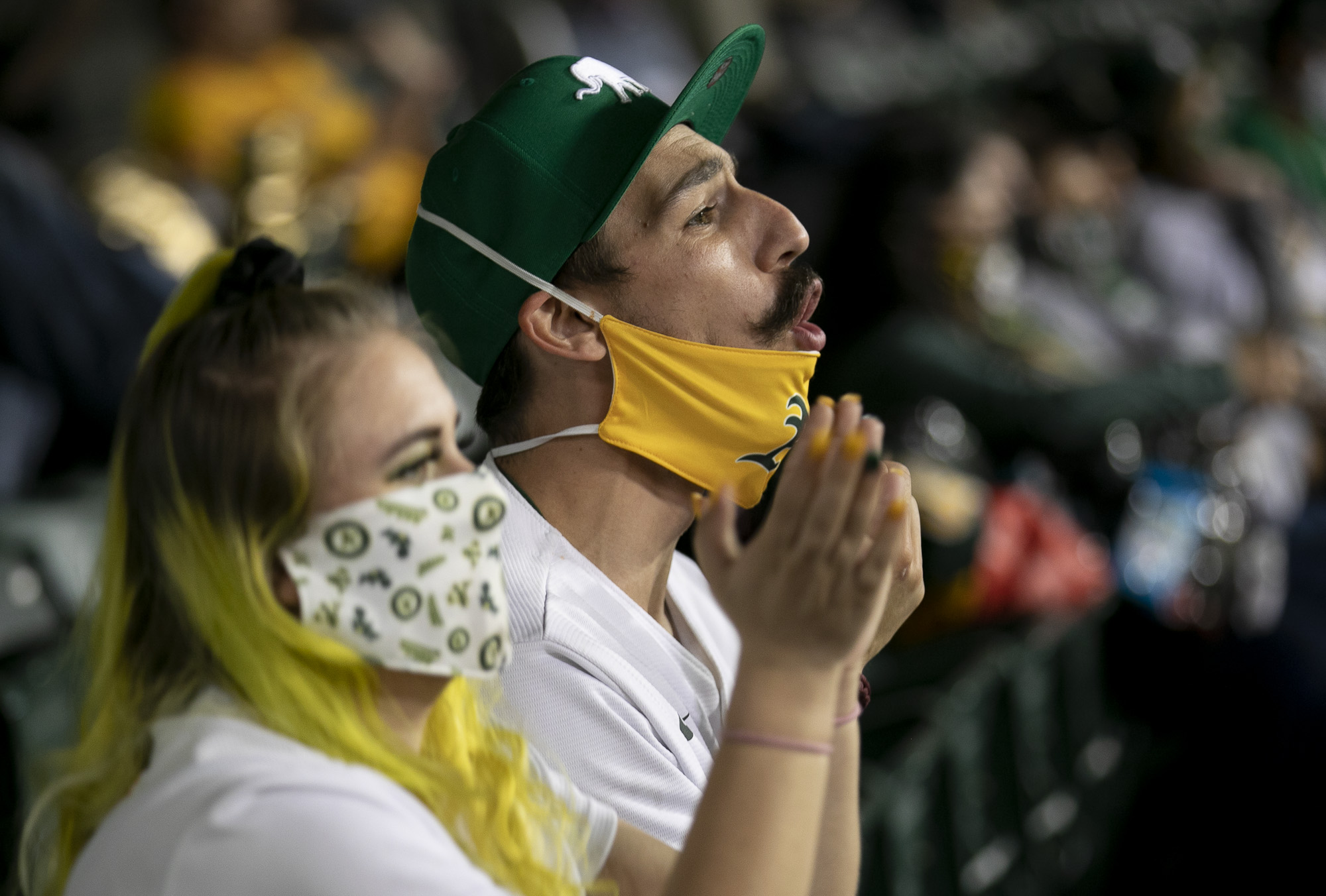 Darby Nastasia, left, and fiancé David Baker, cheer from the stands.