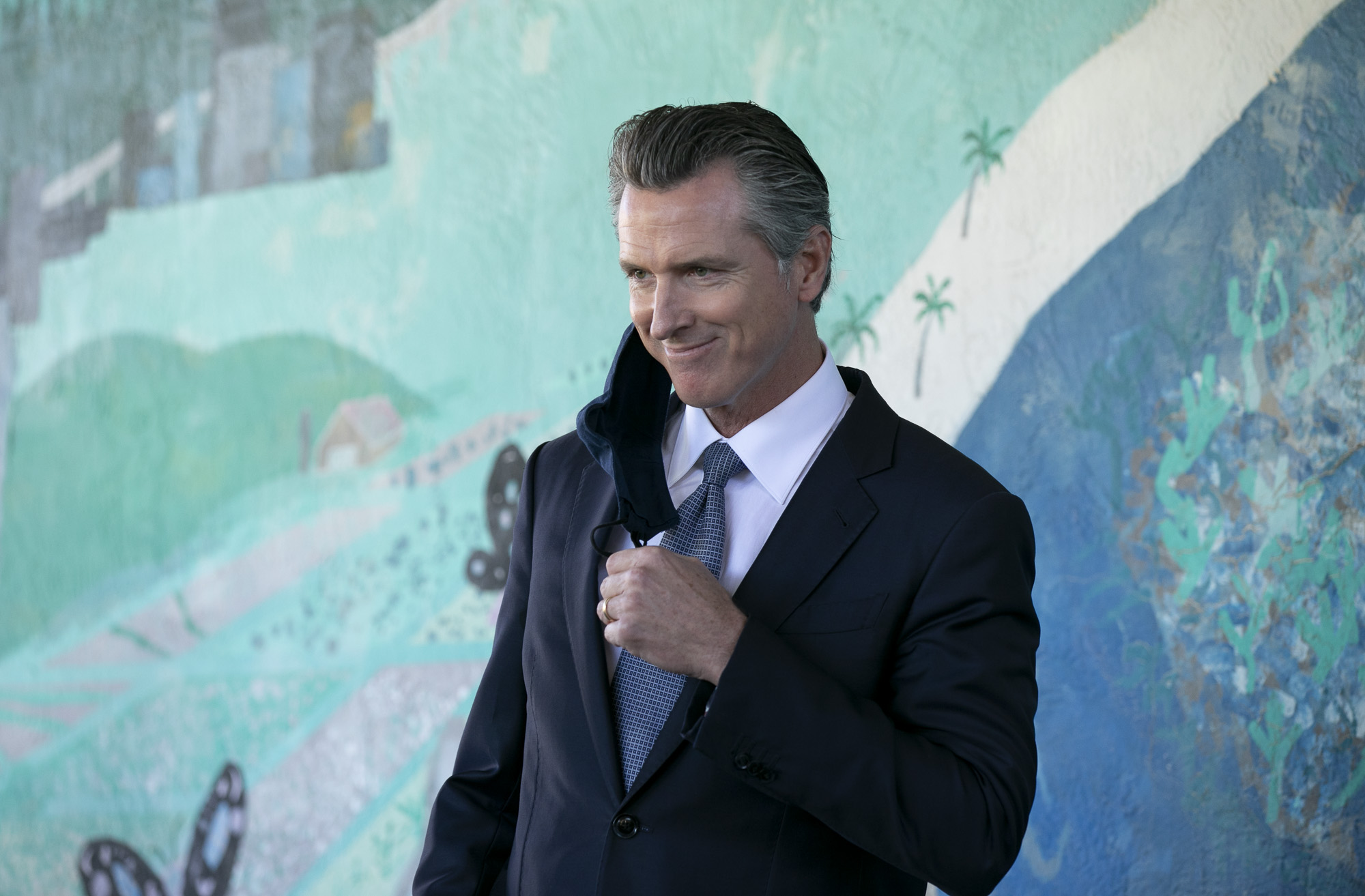 Gov. Gavin Newsom prepares to speak at a press conference to announce a new requirement for all school teachers and employees to show proof of vaccination or to undergo weekly COVID-19 testing, at Carl B. Munck Elementary School in Oakland on Aug. 11, 2021. Photo by Anne Wernikoff, CalMatters