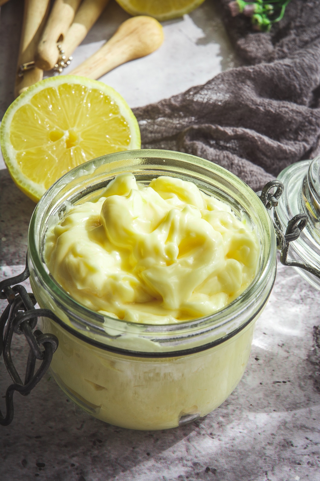 Paleo Mayo in jar with lemon in background and grey napkin