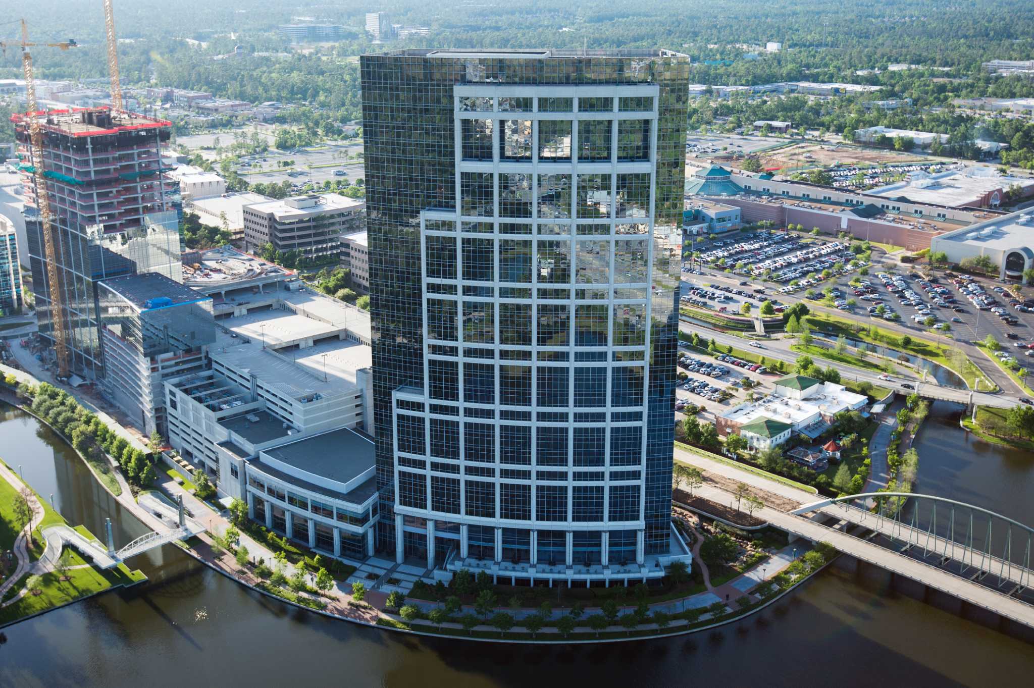 The Anadarko Tower in The Woodlands Town Center, along with construction of a new second tower seen at left, is seen on Thursday, April 11, 2013. Anadarko Petroleum Corporation is constructing a second office tower with a total of 550,000 square fee that is planned for completion in 2014. ( Smiley N. Pool / Houston Chronicle )