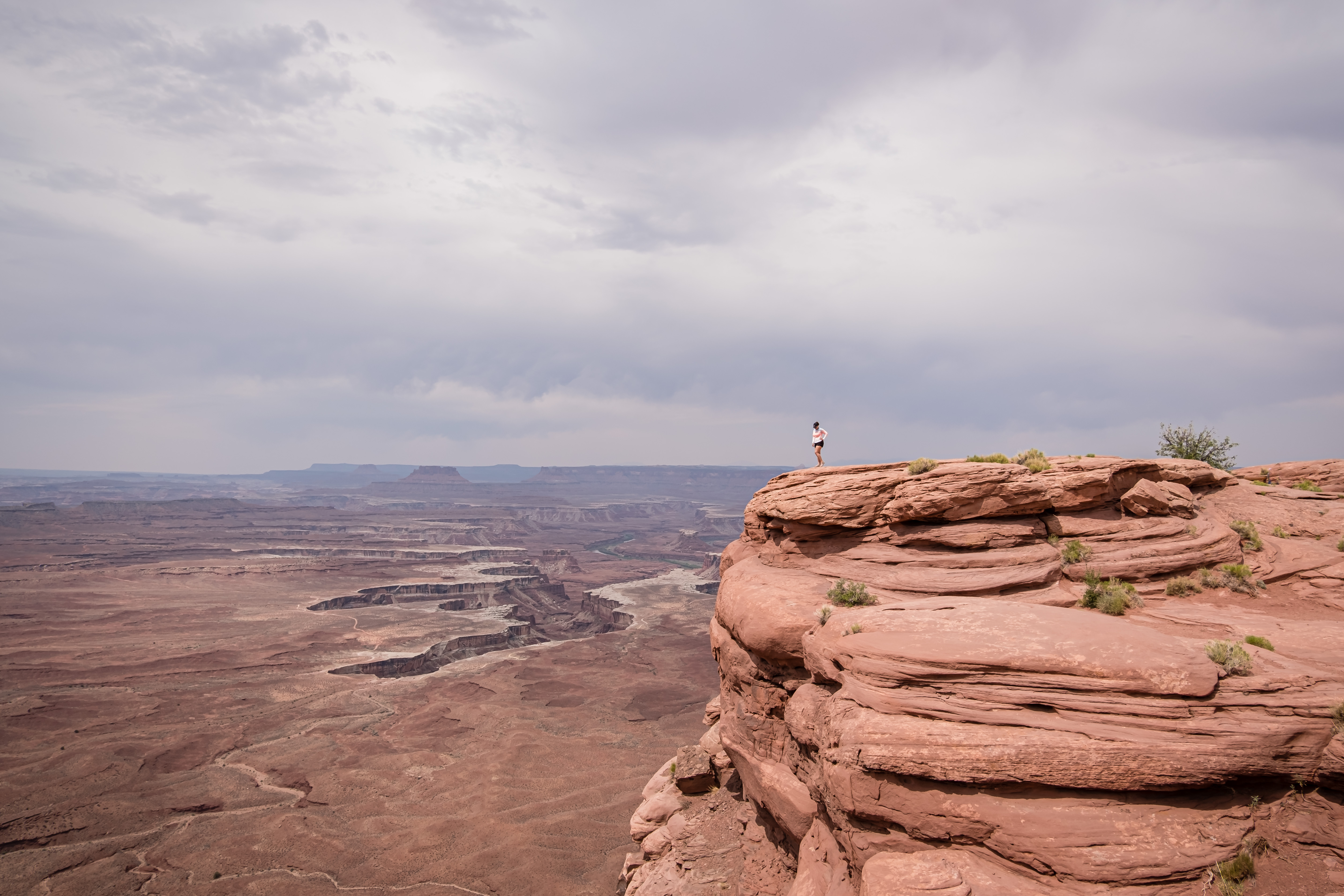 standing on a canyon edge in canyonlands national park