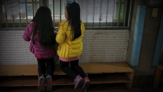 Children Watch As Voters Cast Their Ballots At A Polling Station During General Elections In Taipei