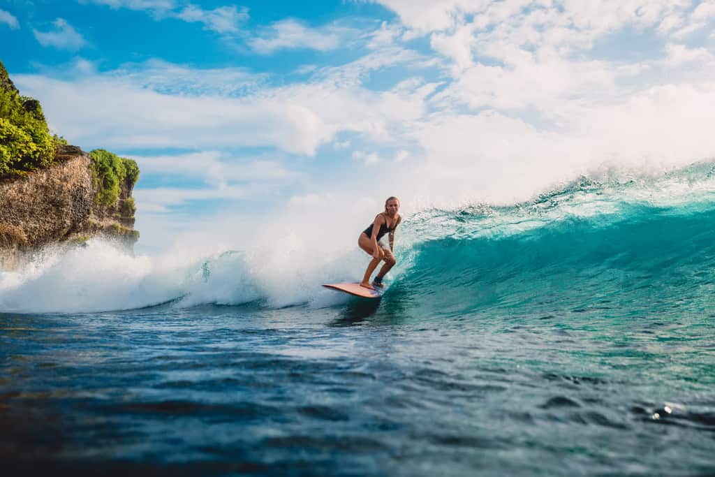 woman surfing in Bali