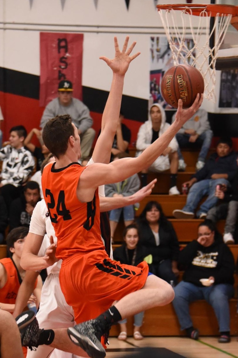 Kelseyville's Joey Mendonca takes the ball to the hoop in a league game against archrival Clear Lake played nearly a year ago today in Lakeport. (Photo courtesy of Trett Bishop)