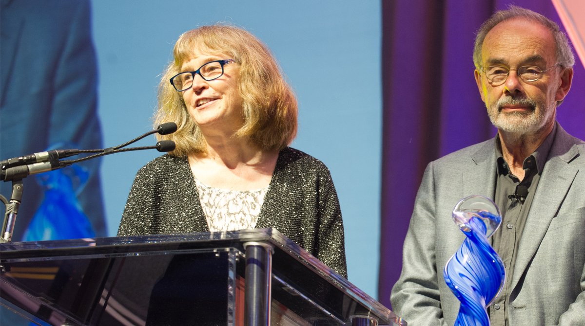 Jan Walker and Dr. Tom Delbanco speak at a podium.