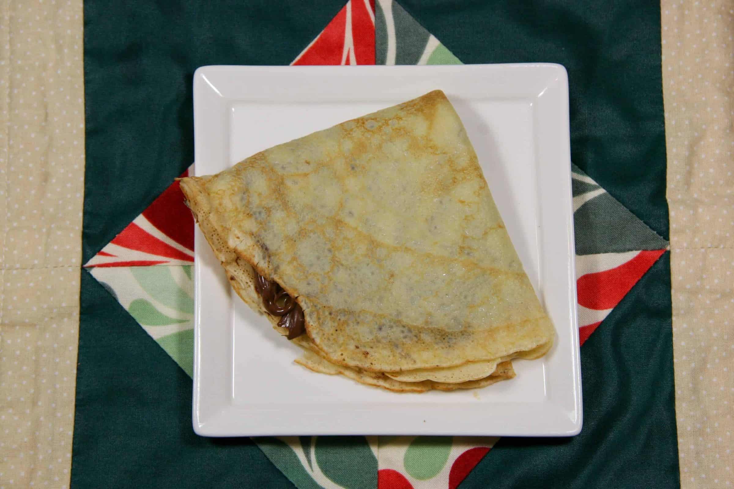 nutella crepe on a plate on a background