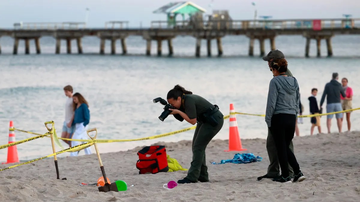 Young girl dies after being buried alive digging sand on Florida beach