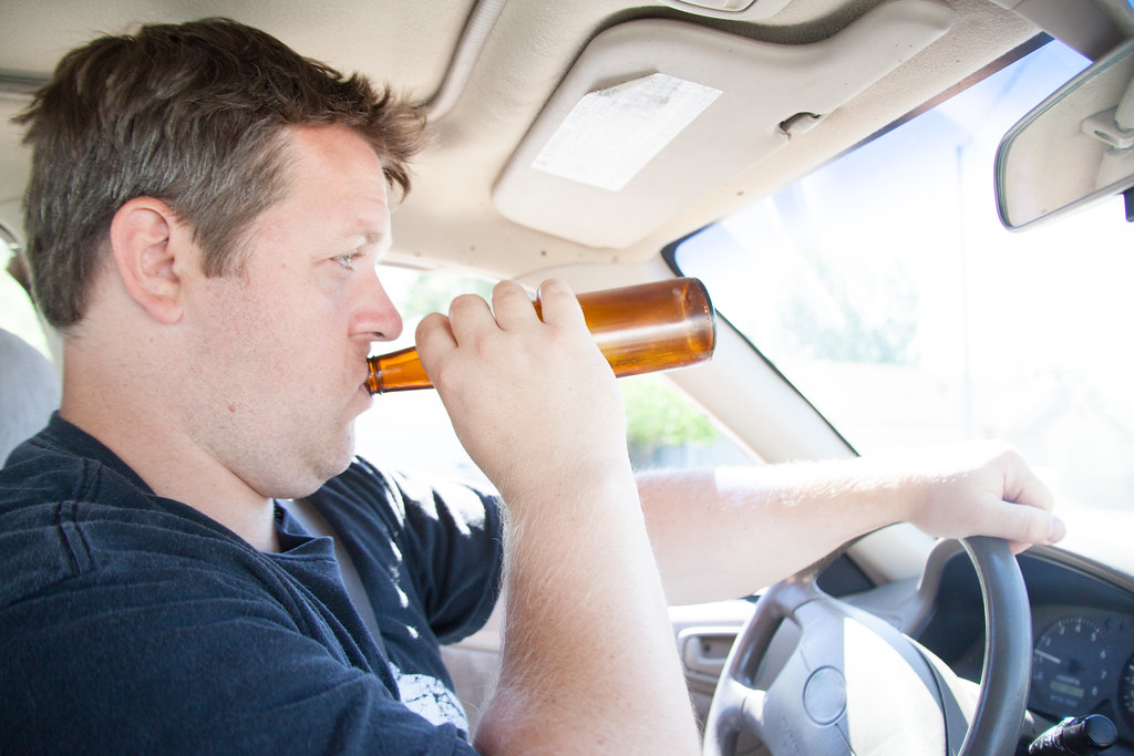 Man Drinking & Driving w/ Beer When using this image pleas… Flickr