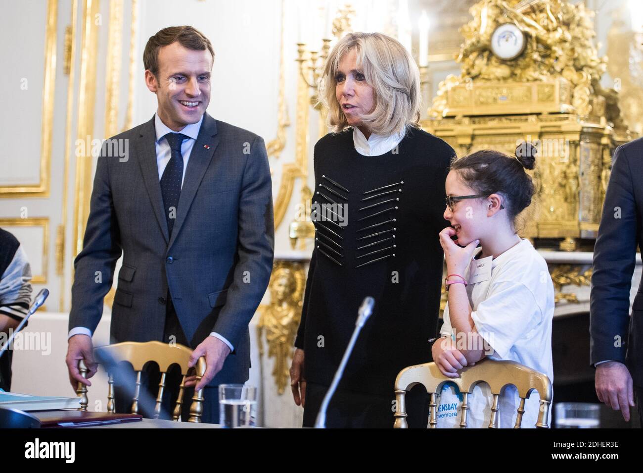 French President Emmanuel Macron and his wife Brigitte receive children