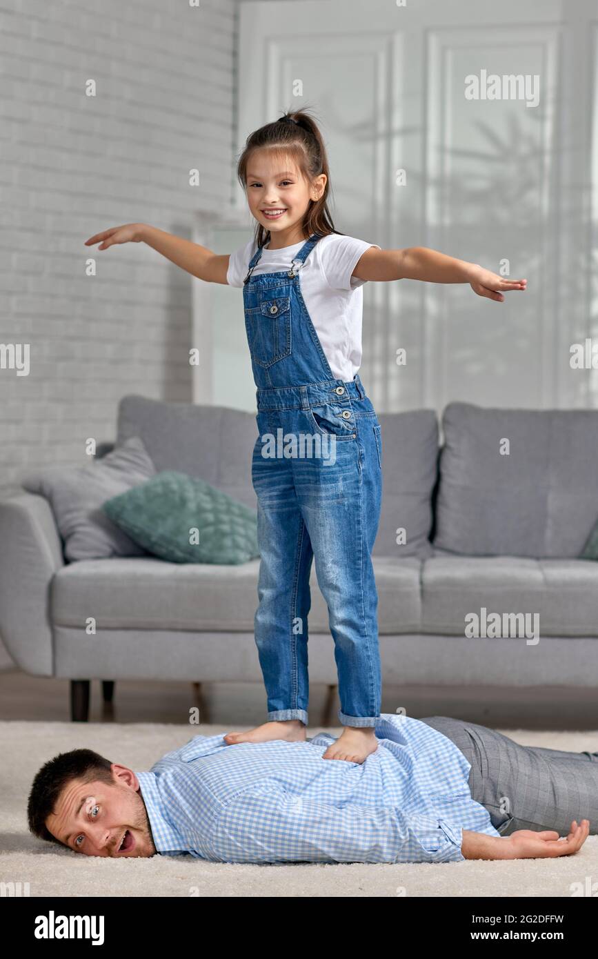 happy little child daughter doing massage to father Stock Photo Alamy