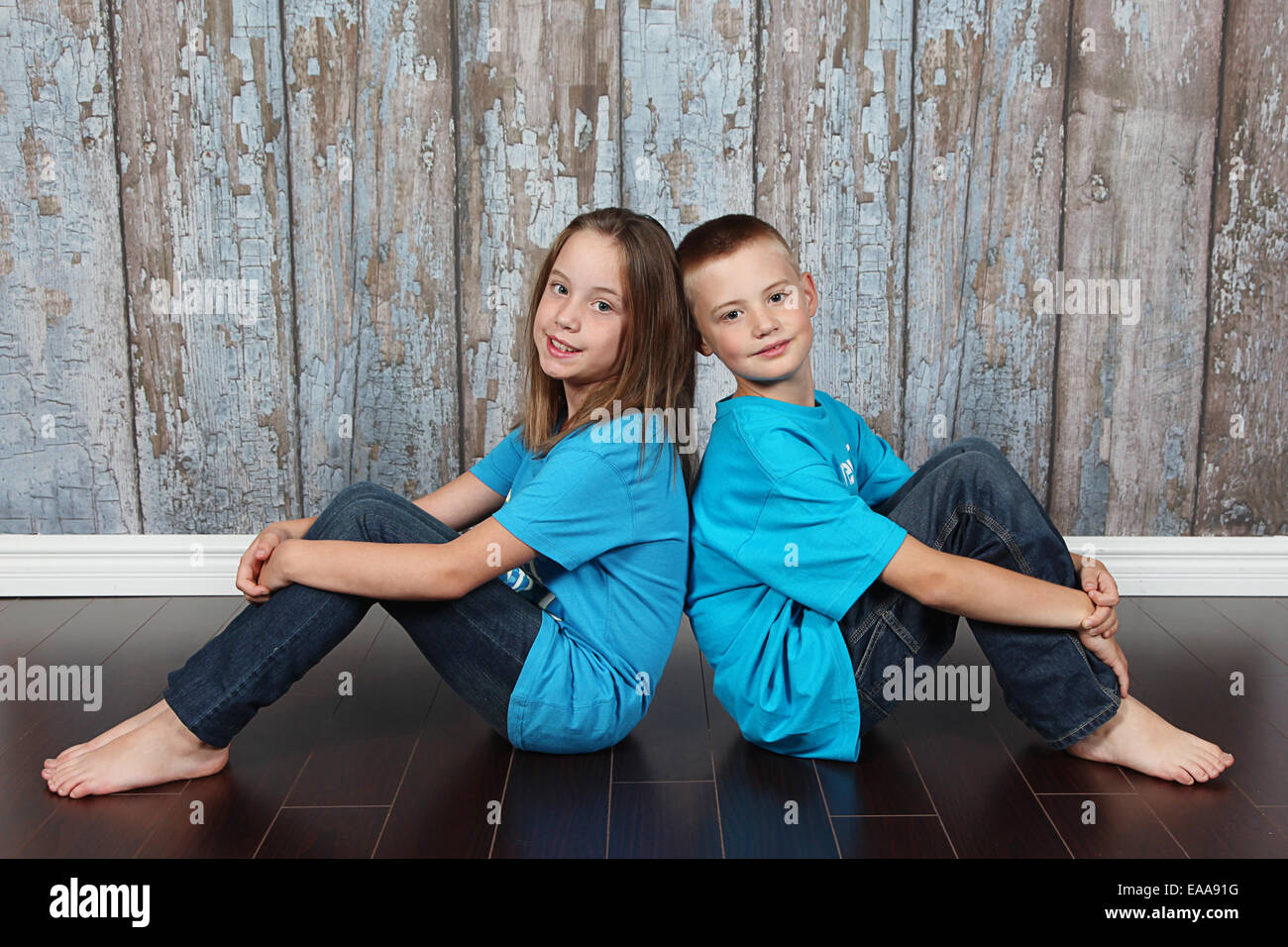 Twin brother and sister posing together in studio Stock Photo Alamy