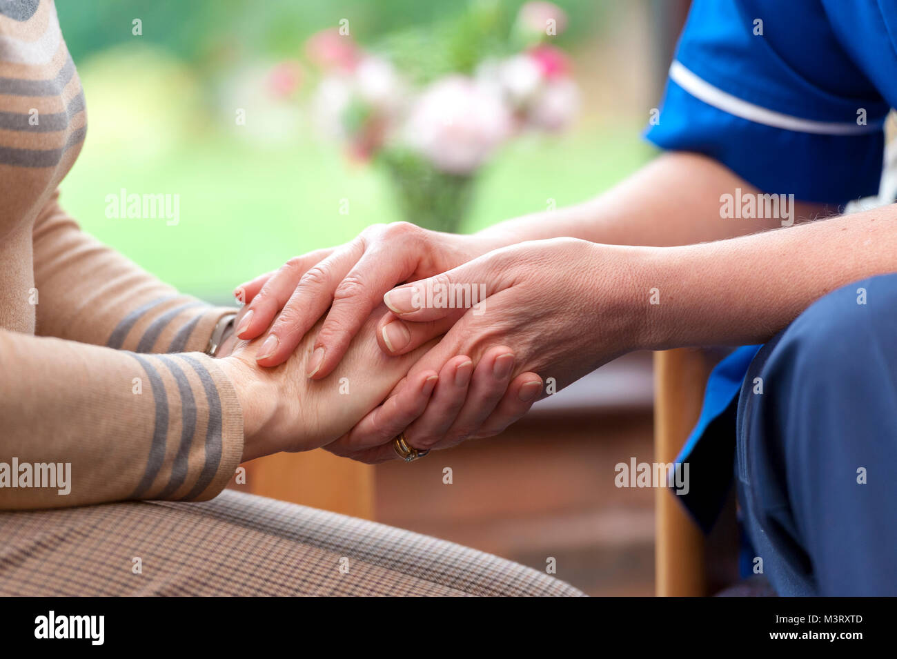 Caring hands nurse comforts a patient at home Stock Photo Alamy