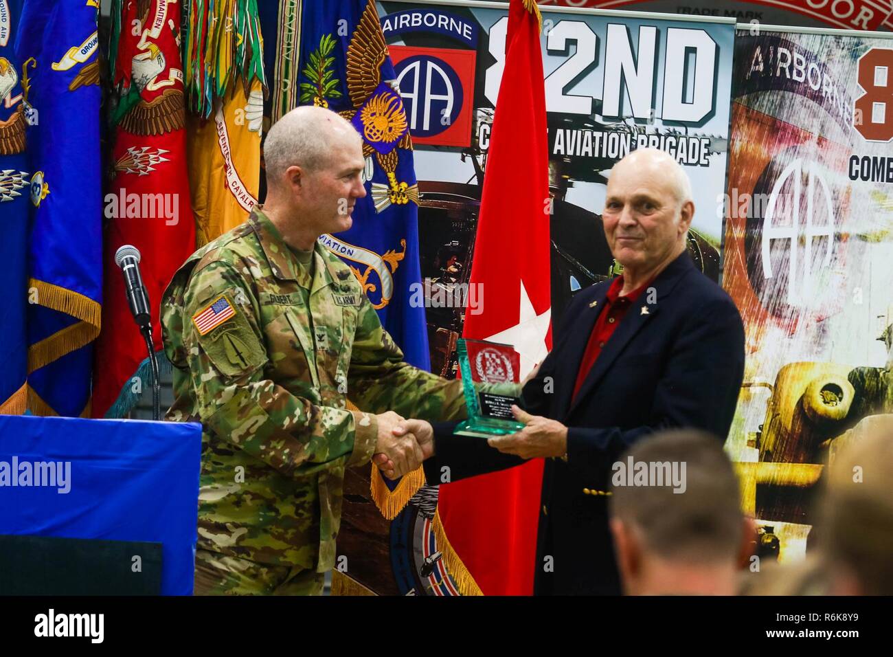 Col. Erik Gilbert, the 82nd Combat Aviation Brigade commander, presents