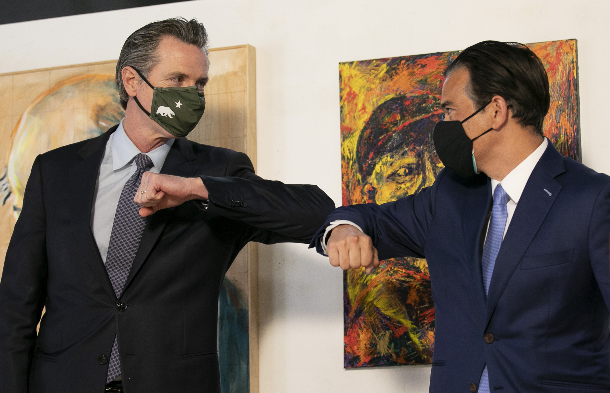 Gov. Gavin Newson, left, and Assemblymember Rob Bonta bump elbows during a press conference announcing Bonta's nomination for Attorney General at the International Hotel Manilatown Center in San Francisco on March 24, 2021. Photo by Anne Wernikoff, CalMatters