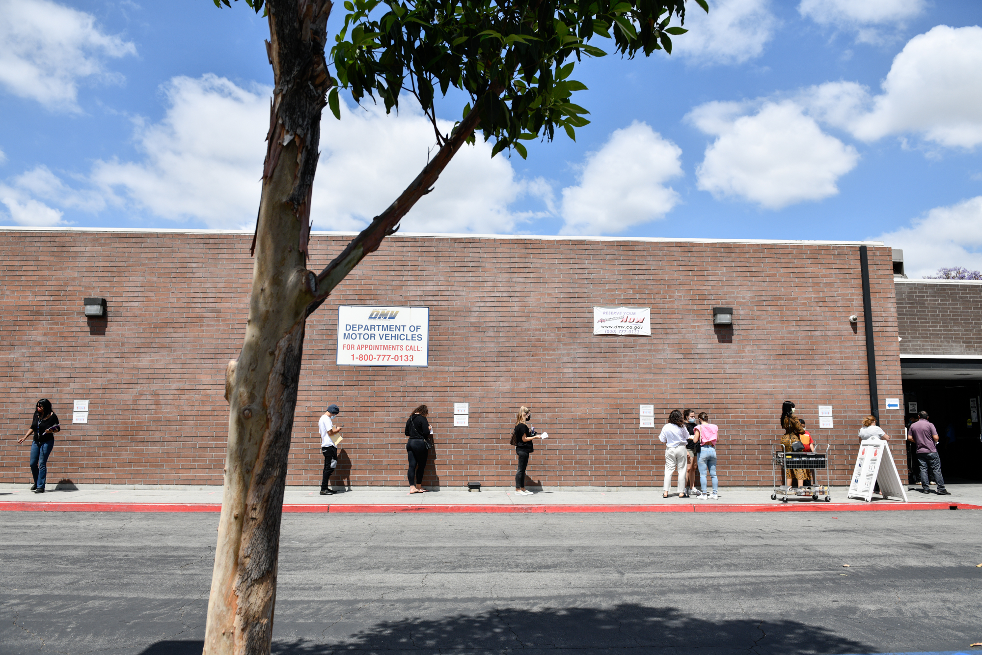 People wait in line outside of the state Department of Motor Vehicles office in Bellflower, on June 8, 2021. Pablo Unzueta for CalMatters