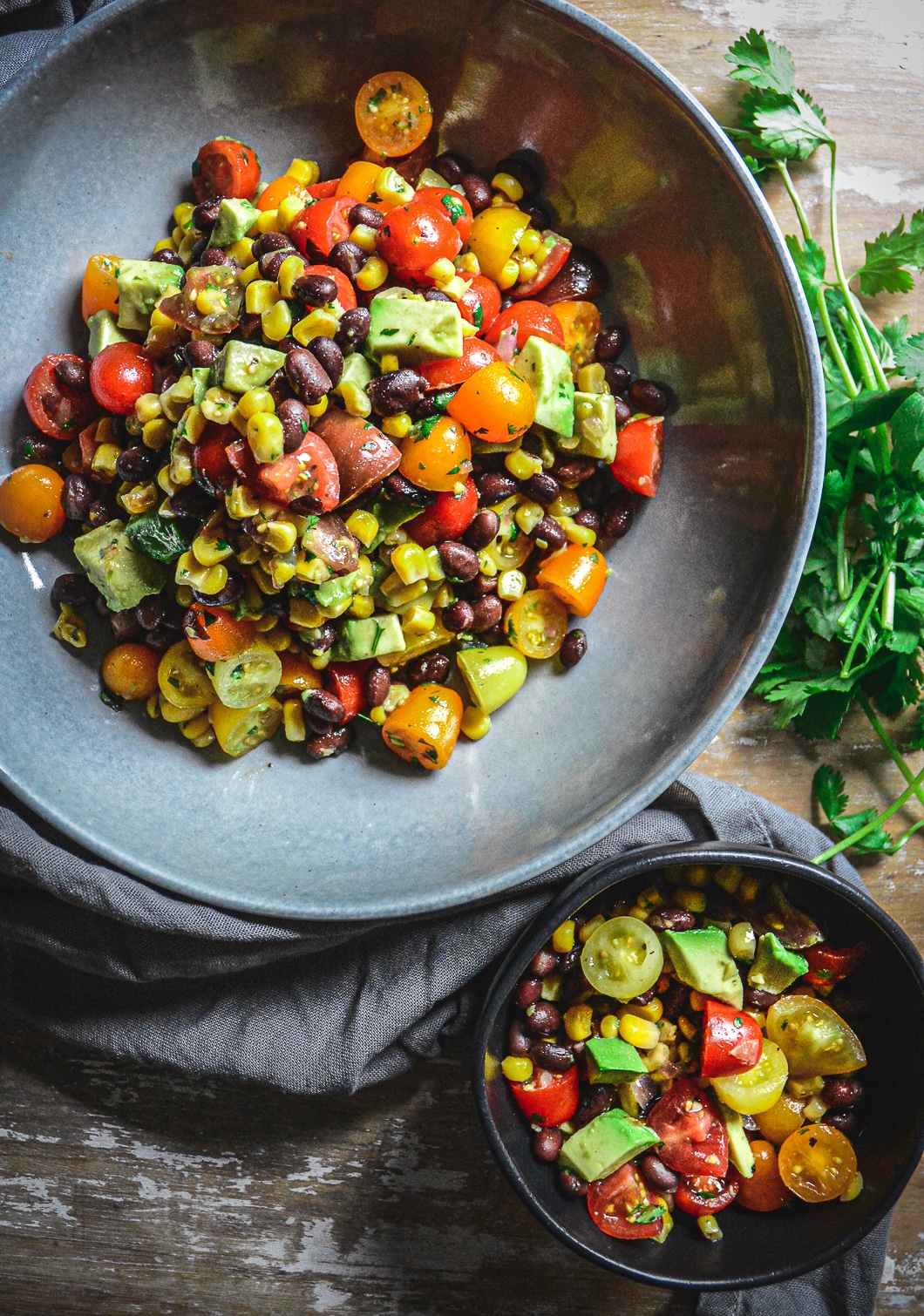 Mexican tomato salad in bowls with cilantro and napkin