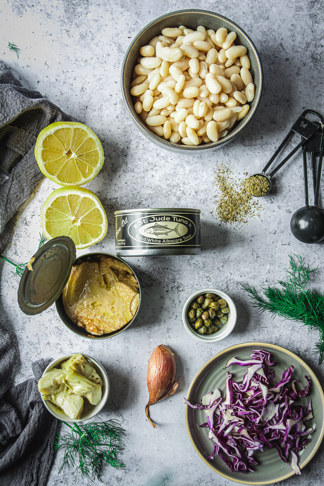 White Beans, artichokes, cans of tuna, lemons, sliced cabbage and dried oregano