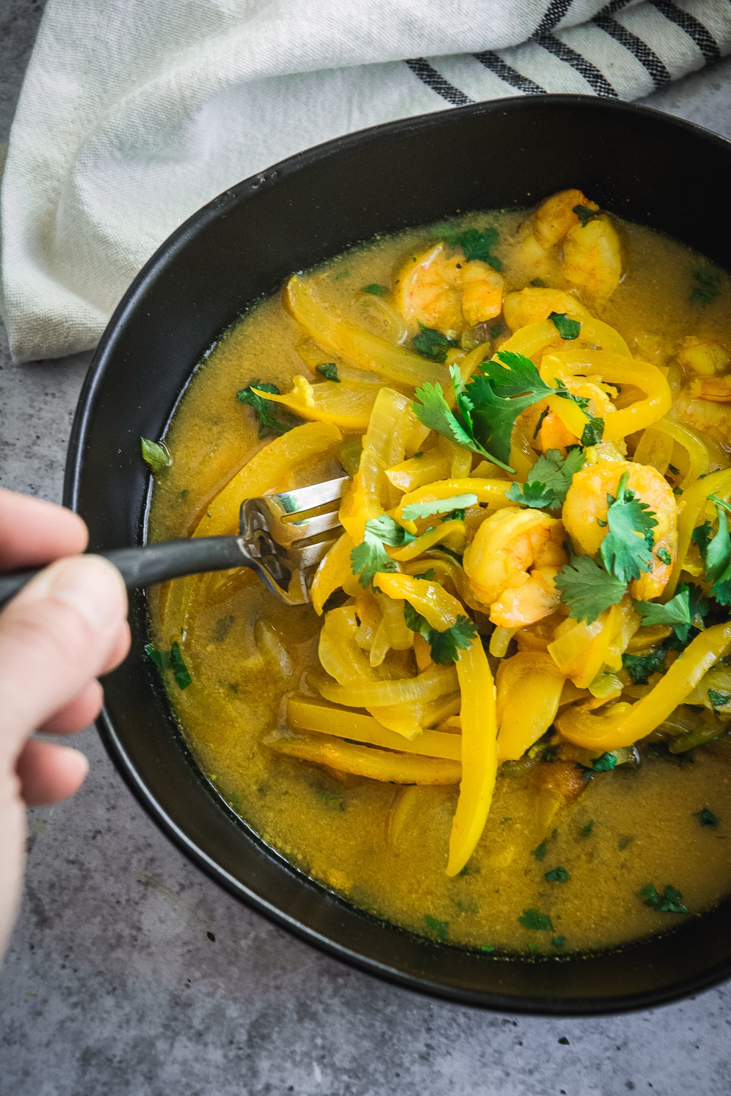 Shrimp tagine in bowl with fork