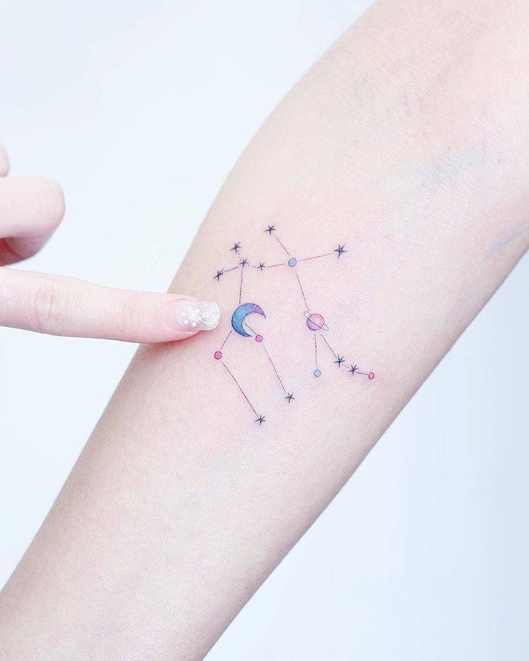 Gemini constellation tattoo on the right inner forearm.