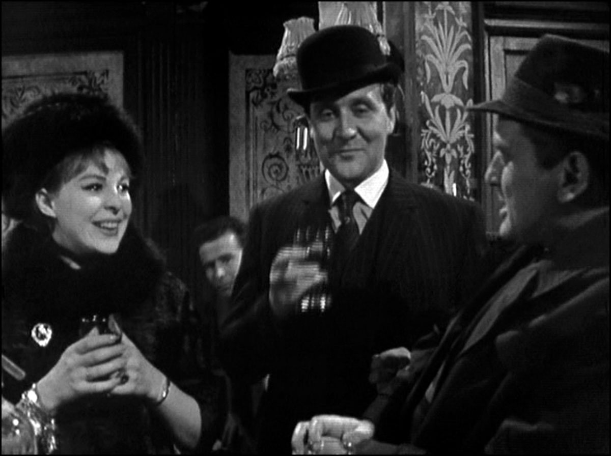 In the oldfashioned, woodpanelled pub, Steed, centre stage, shares a