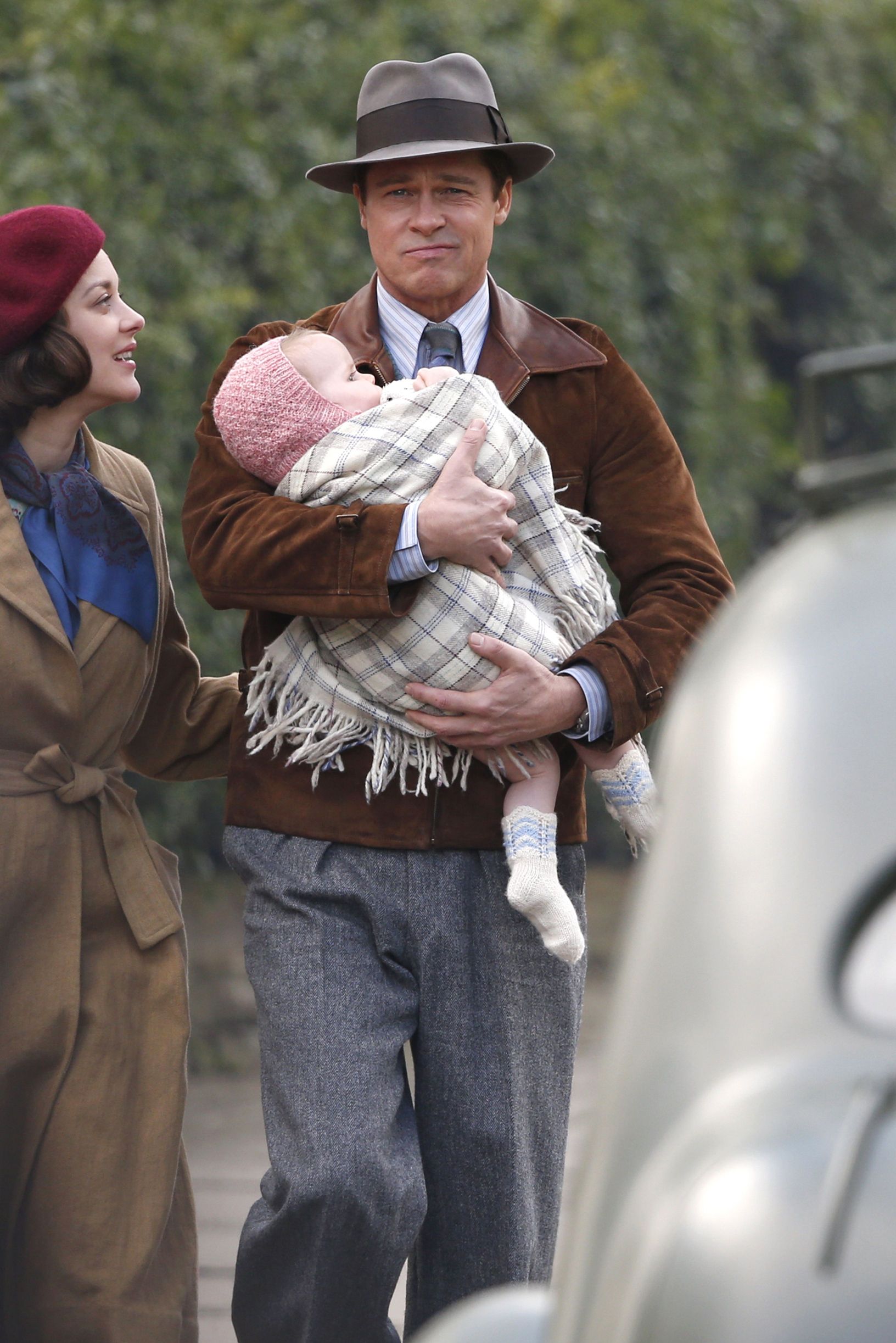 Brad Pitt plays a doting parent with Marion Cotillard on set in London