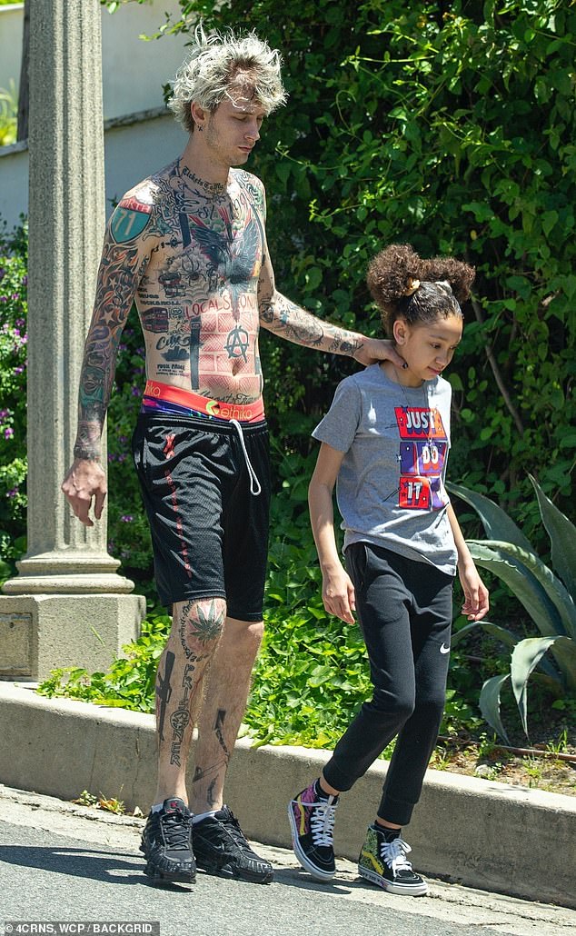 Machine Gun Kelly goes for a jog with his daughter Casie, 11, amid