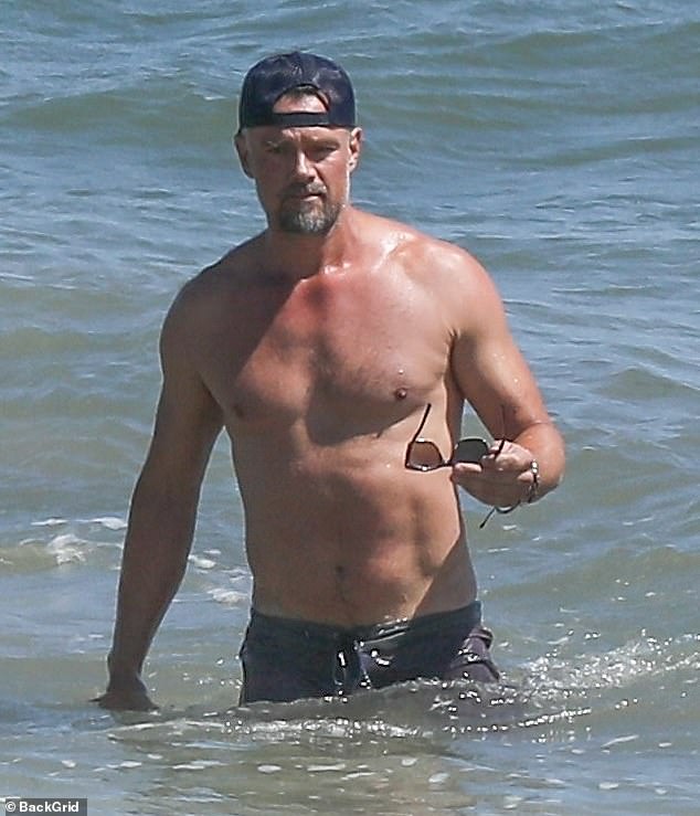 Josh Duhamel shows of his chiseled chest as he enjoys an open water