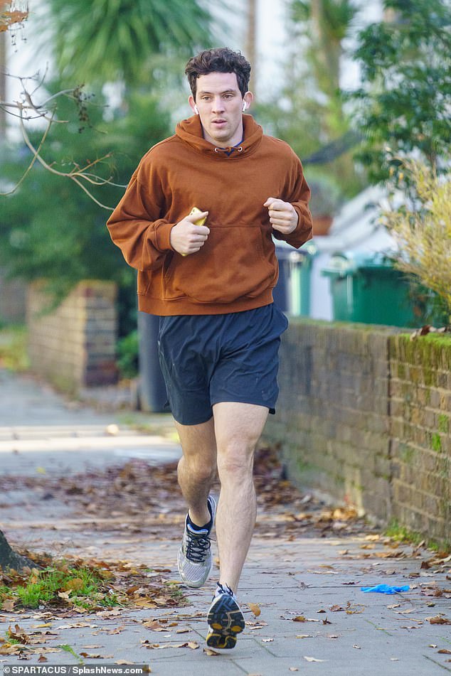 The Crown's Josh O'Connor cuts a casual figure in a hoodie and shorts